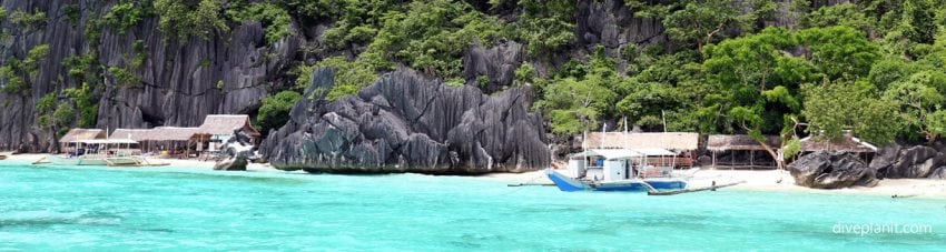 Boats at the waters edge at Coron Island diving the Philippines in the Philippines by Diveplanit
