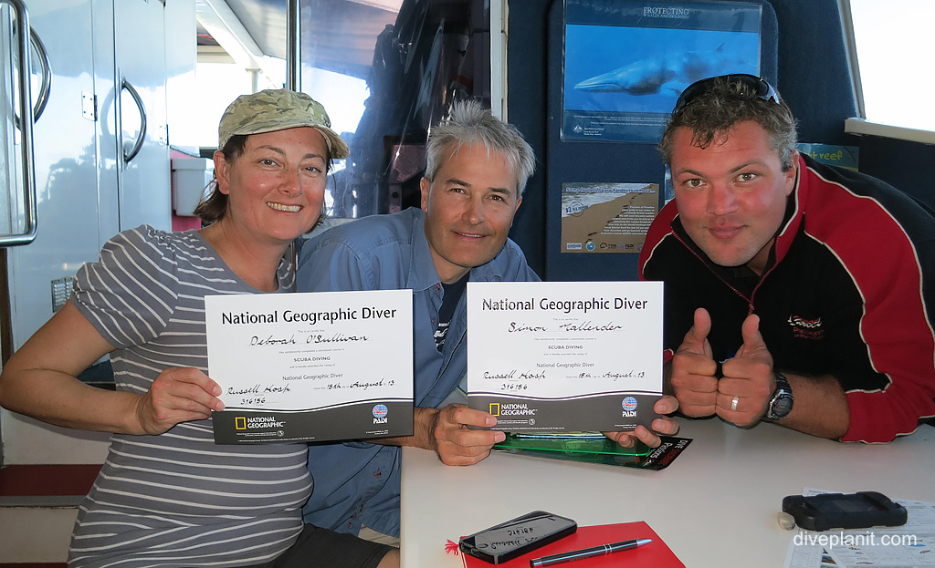Receiving our National Geographic Diver Certificates at Paradise Reef. Diving holiday, travel planning tips for Great Barrier Reef - where, when, who and how