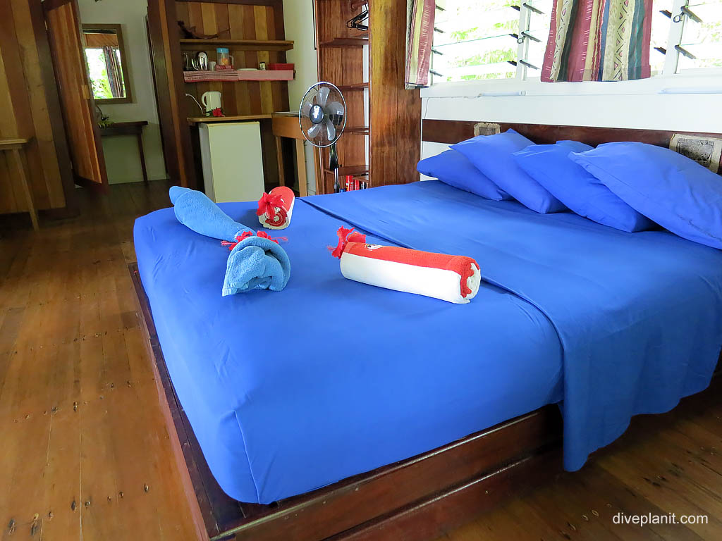 Double bed in bungalow diving Uepi at Uepi Resort in the Solomon Islands by Diveplanit