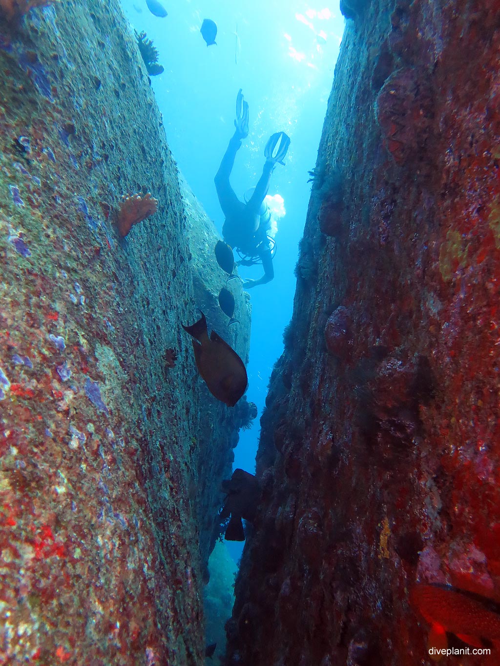 Diver in the gap between the boulders at Ko Bangu North Point diving with Sea Bees. Scuba holiday travel planning for Thailand - where, who and how