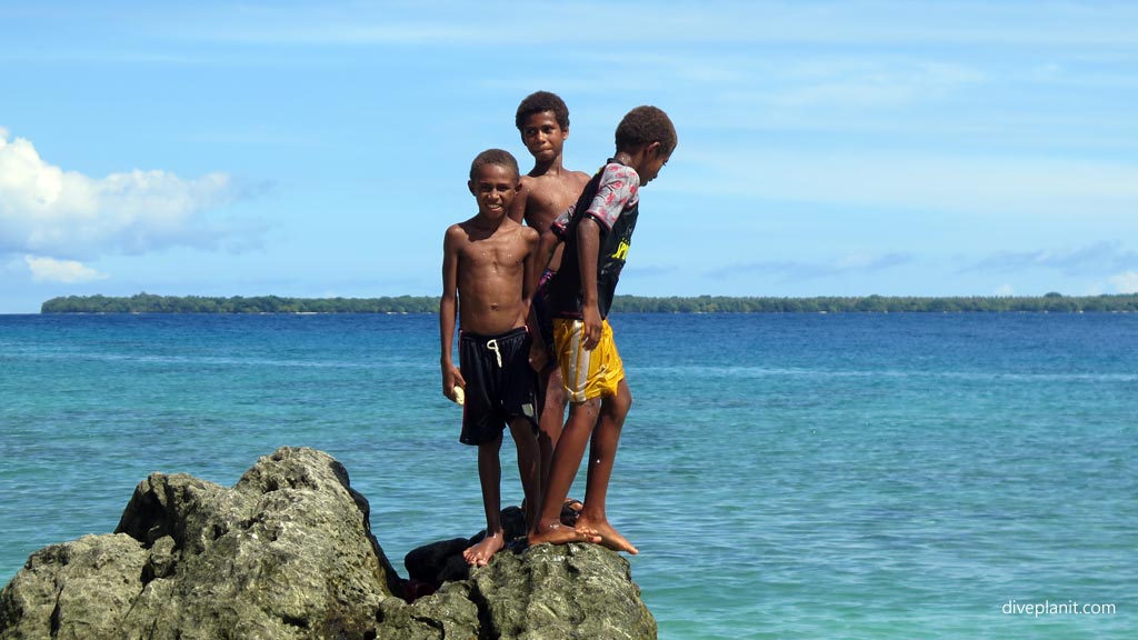 Local kids at Million Dollar Beach at Espiritu Santo diving Vanuatu by Diveplanit