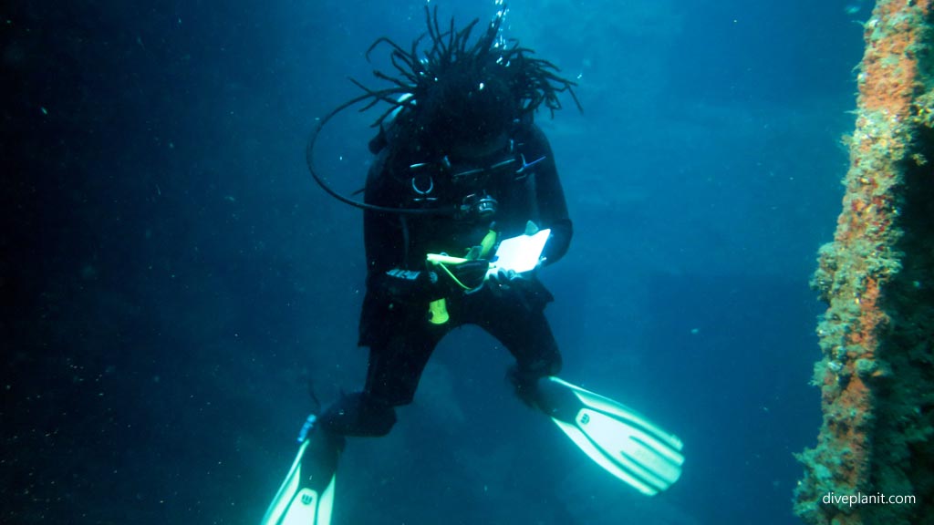 Yan writes down everything we see on the slate diving SS President Coolidge wreck at Espiritu Santo diving Vanuatu by Diveplanit