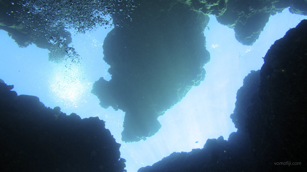 Silhouette of overhanging rock at Subway diving Vomo in the Fiji Islands by Diveplanit