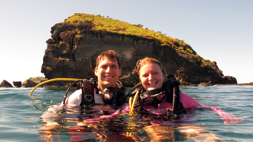 Same diving couple in the water diving Vomo with Vomo Island Resort PADI dive centre in the Fiji Islands by Diveplanit