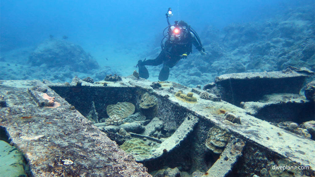 Diver amongst the wreckage at Mataora Wreck diving Rarotonga in the Cook Islands by Diveplanit