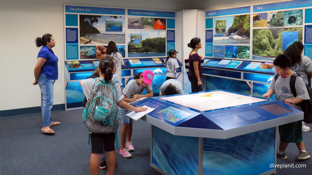 Joseph asking questions at the standing exhibit in The Ocean Center American Samoa by Diveplanit