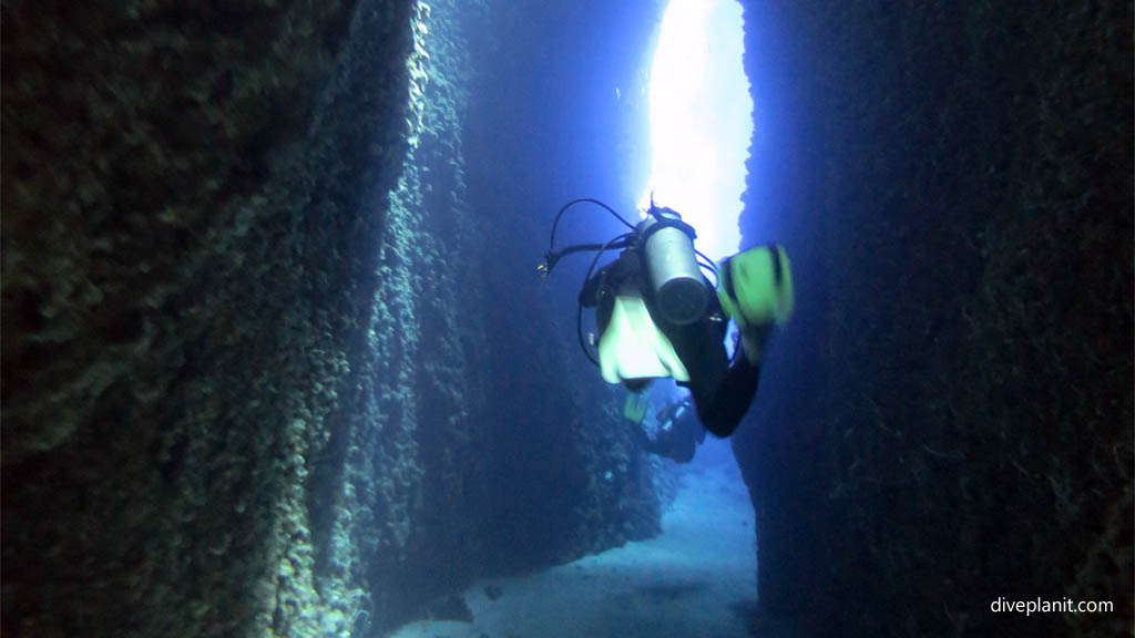 Single diver in the slot diving Leru Cut at Russell Islands Solomon Islands by Diveplanit