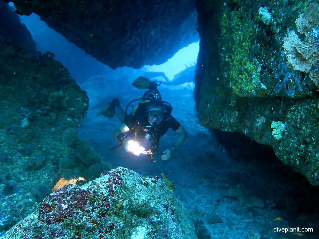 Diver in gap between the massive rocks at Hin Pusa diving with Sea Bees. Scuba holiday travel planning for Thailand - where, who and how