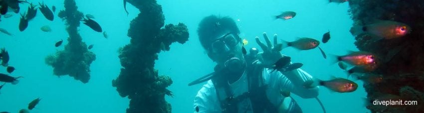 Our dive guide beam through the wreck at king cruiser wreck diving andaman sea banner