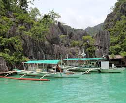 Boats at the waters edge at diving coron palawan philippines feature