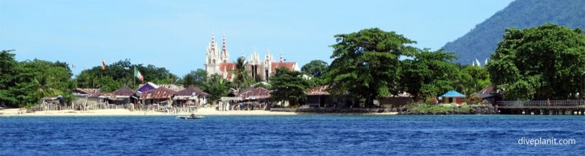 Locality mosque and shacks in the foreground at bunaken point diving with thalassa resort banner