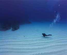 Diver over sand in the distance at ippon ishi diving yonaguni okinawa japan diveplanit feature