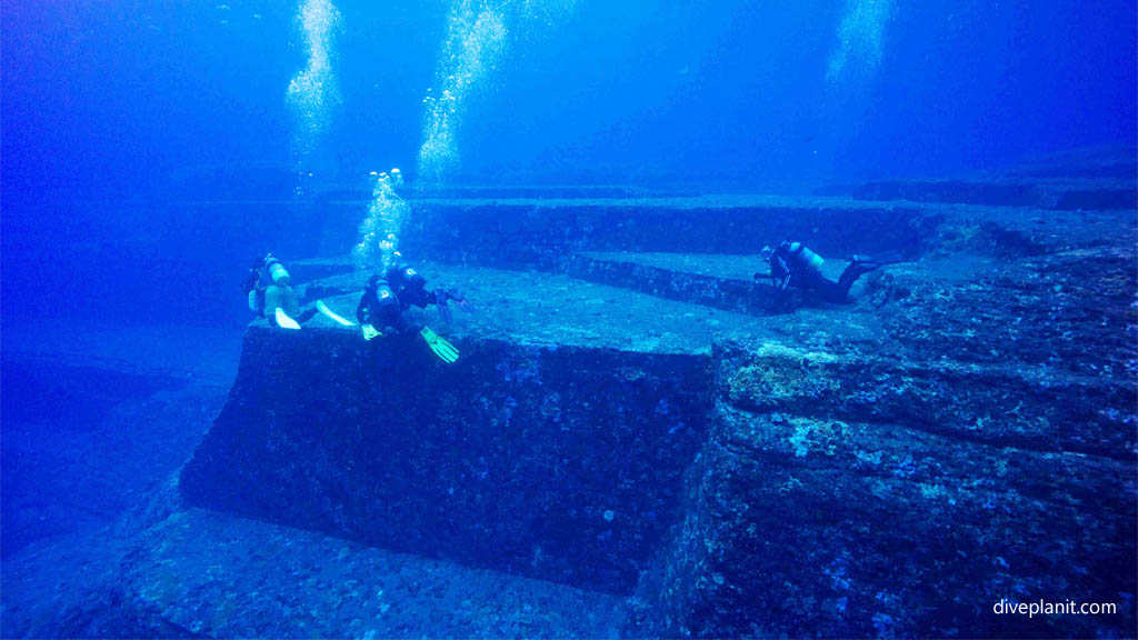 Divers for scale at Monument diving Yonaguni Okinawa Japan by Diveplanit