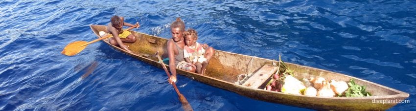 Villagers in canoe diving mane bay in the russell islands aboard mv taka solomon islands diveplanit banner