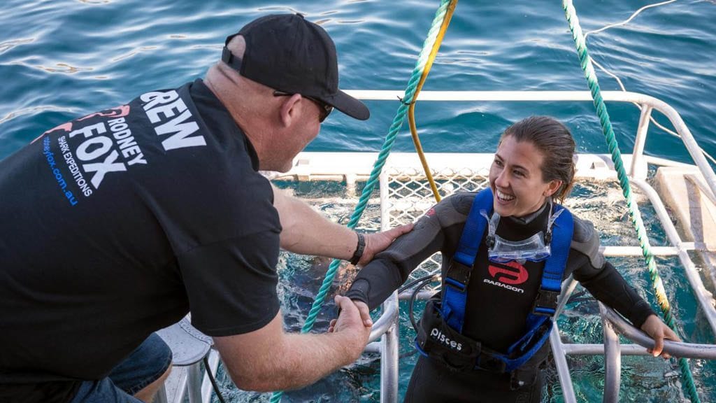 Rodney fox expeditions great white shark cage diving south australia crew give helping hand